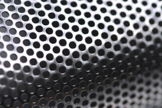 Abstract background of perforated metal with very shallow depth
